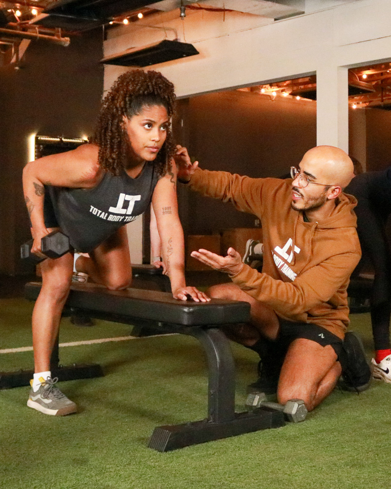 woman in 30s in a personal training class with a trainer from total body training in san antonio